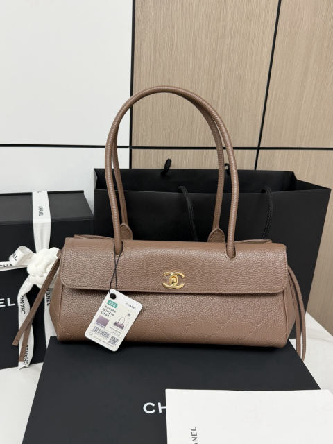 CHANEL baguette bag with lychee pattern and black bowling ball design