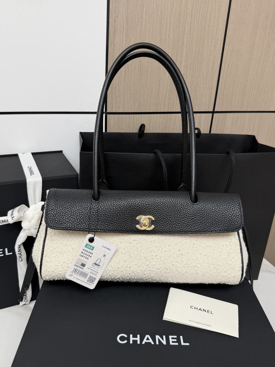 CHANEL baguette bag with lychee pattern and black bowling ball design