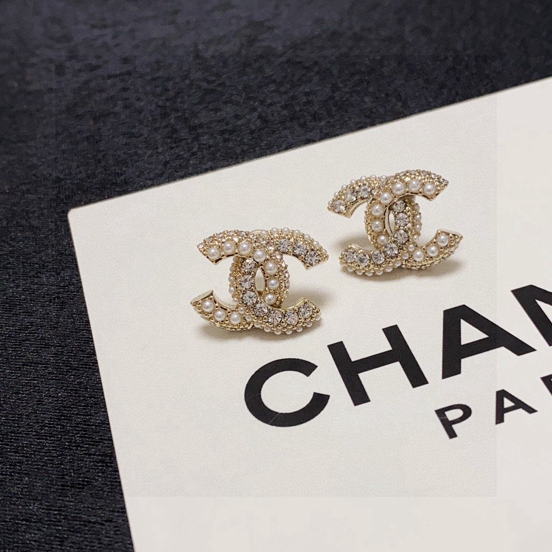 Chanel's stylish and unique double C earrings adorned with pearls and diamonds.