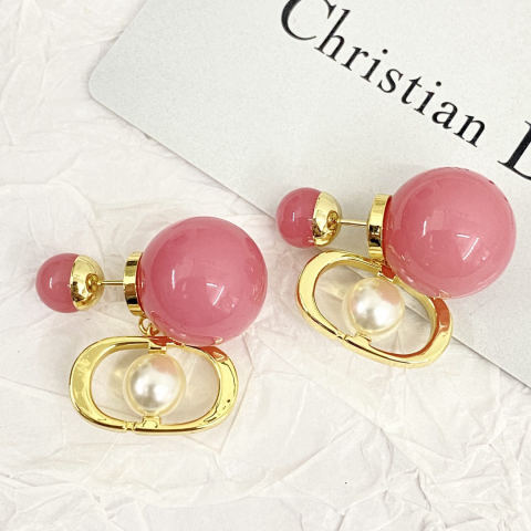 Dior earrings, candy-colored large and small pearl studs.
