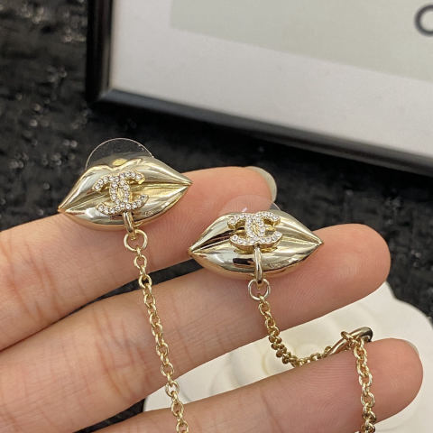 Chanel earrings with a lip design and ear cuff.