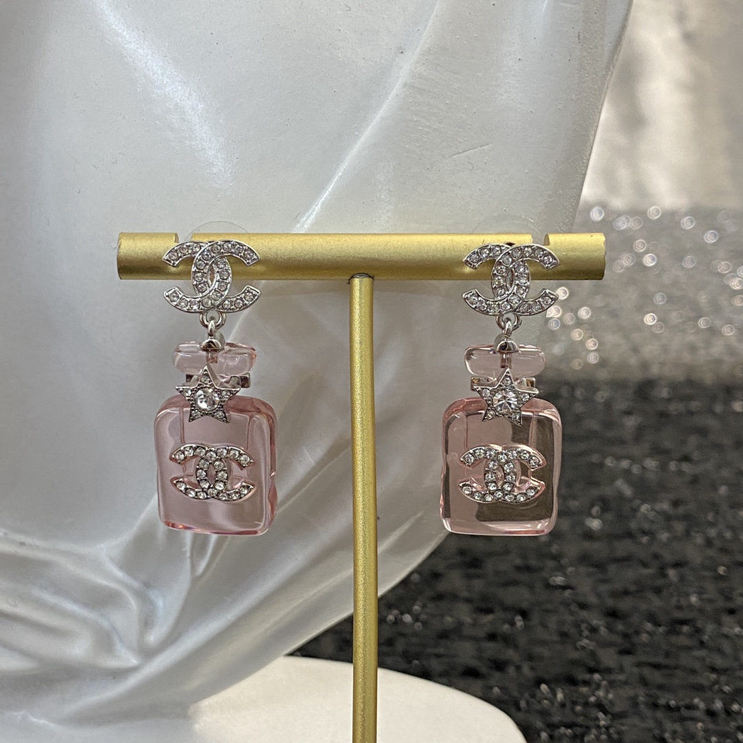 Chanel earrings in a jelly pink perfume bottle design, double C earrings.