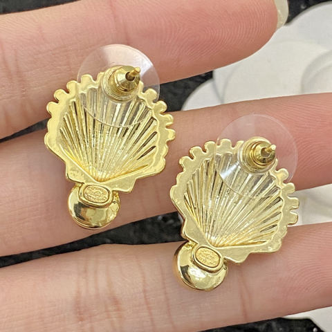 Chanel earrings with rubies, gold shells, and colored diamonds.
