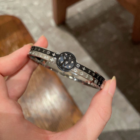 LV monogrammed engraved four-leaf clover unisex gold and black label bracelet