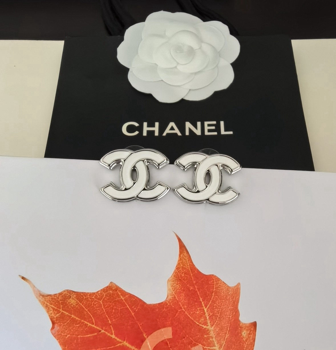 Chanel white gold CC earrings