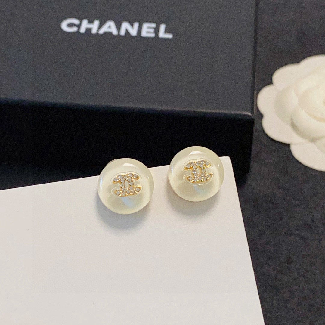 Chanel minimalist summer-style off-white diamond-encrusted stud earrings with the double C logo.