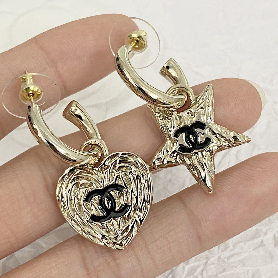 Chanel earrings with asymmetrical hooks and lava star design.